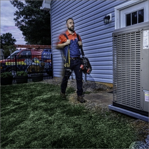 HVAC Worker walking to outdoor unit