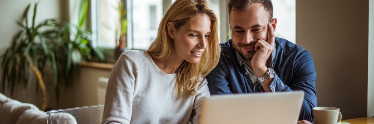 couple looking at offers on their laptop